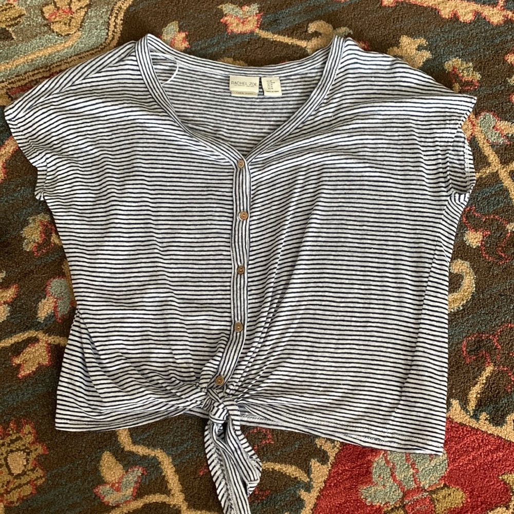 Navy blue and white stripped T-shirt, buttons down the middle, tie at bottom.